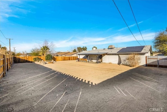 view of front of property featuring solar panels