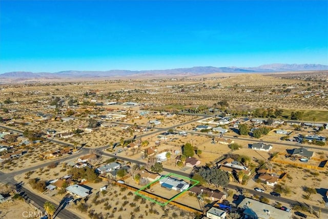 birds eye view of property with view of desert and a mountain view