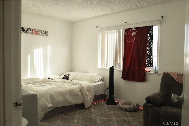 carpeted bedroom featuring a textured ceiling