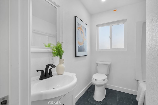 bathroom featuring sink, tile patterned floors, and toilet