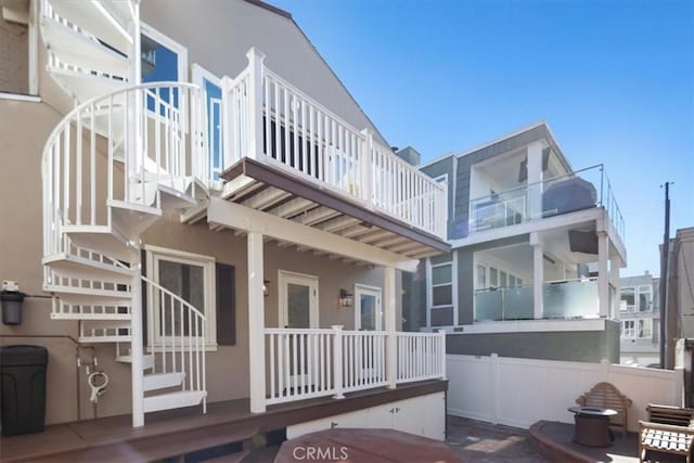 rear view of property with a balcony