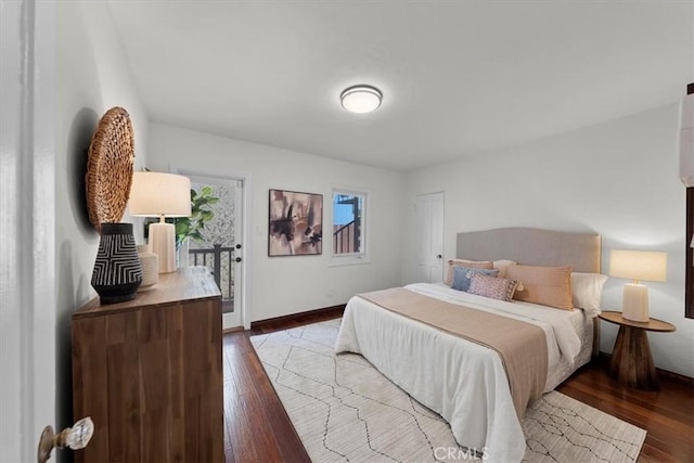 bedroom with access to exterior and light hardwood / wood-style flooring