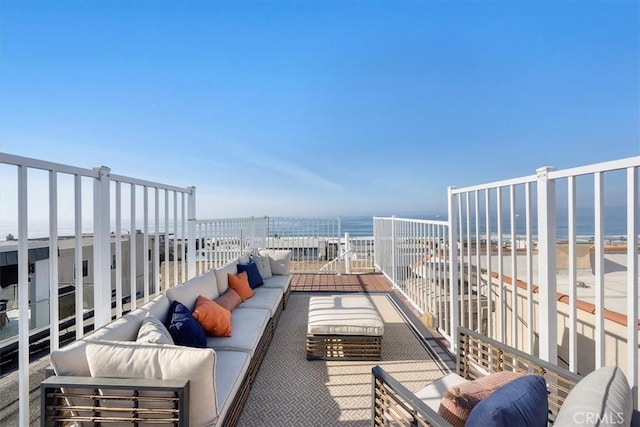 balcony featuring an outdoor hangout area and a water view