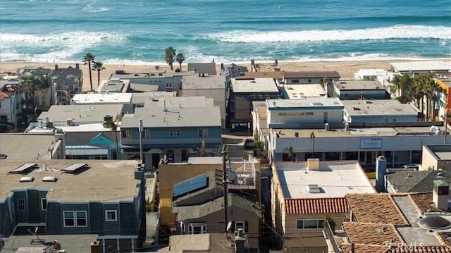 bird's eye view featuring a water view and a beach view