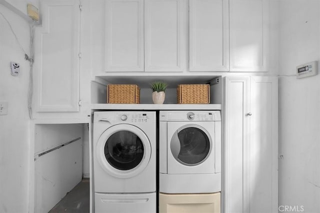 laundry area featuring cabinets and washer and clothes dryer