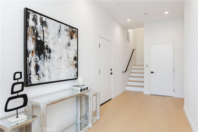 corridor with light hardwood / wood-style flooring