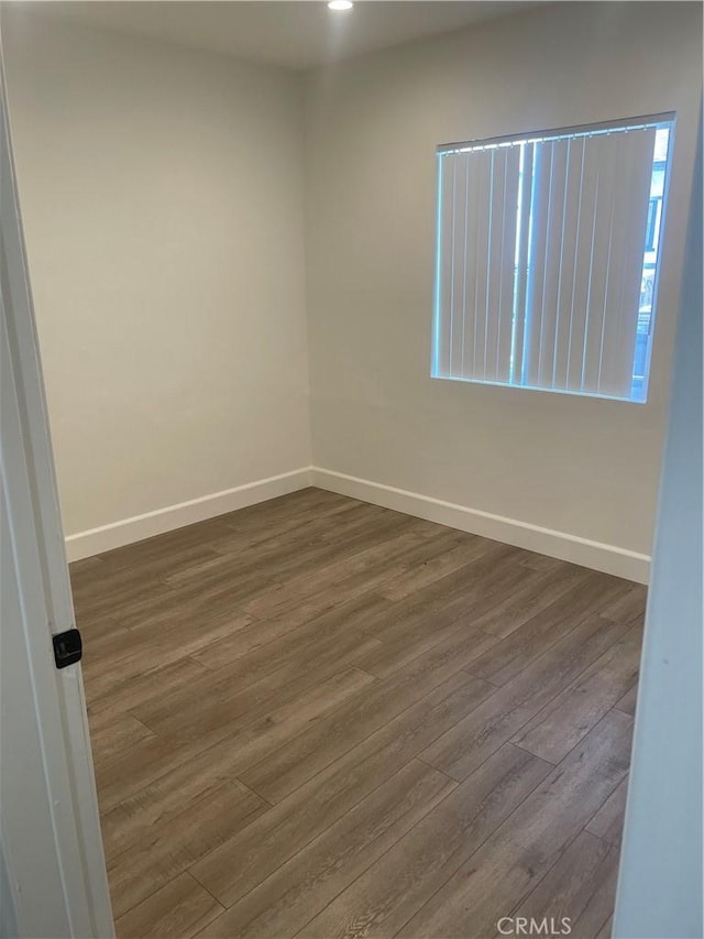 empty room featuring dark wood-type flooring