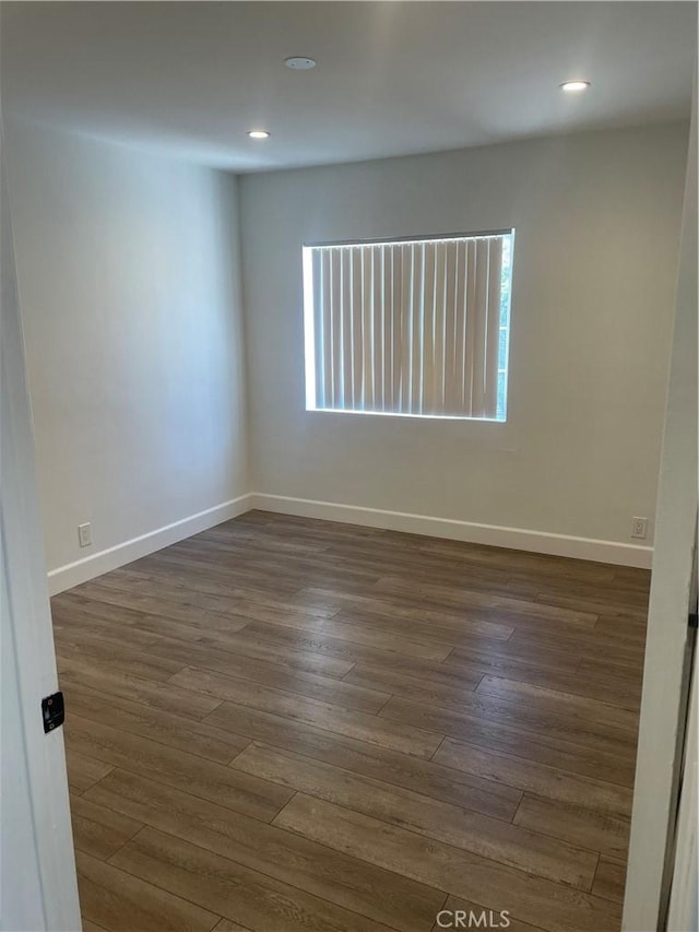 spare room with dark hardwood / wood-style floors