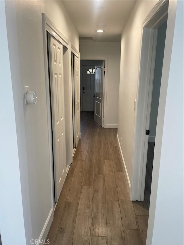 hall with hardwood / wood-style flooring