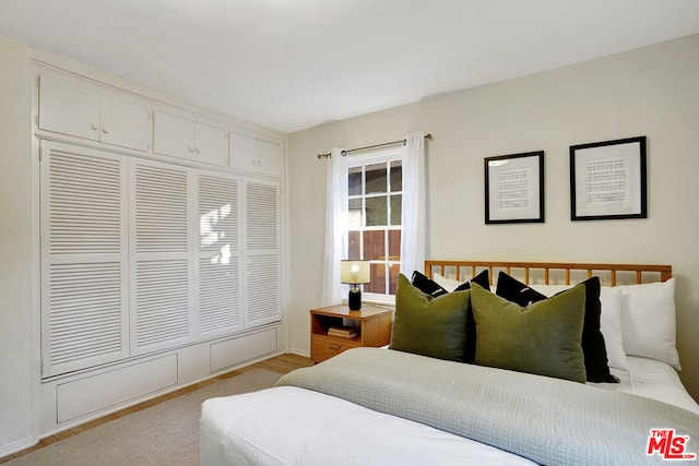 bedroom featuring light hardwood / wood-style floors and a closet