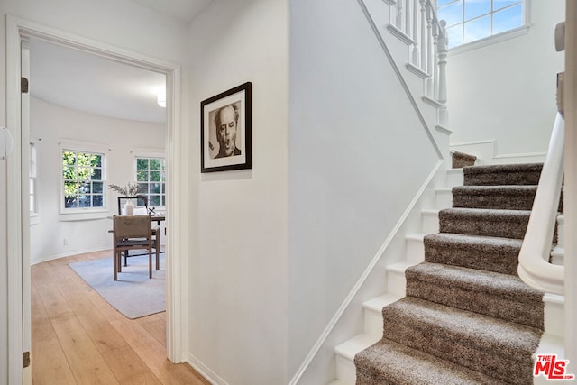 stairs featuring hardwood / wood-style floors