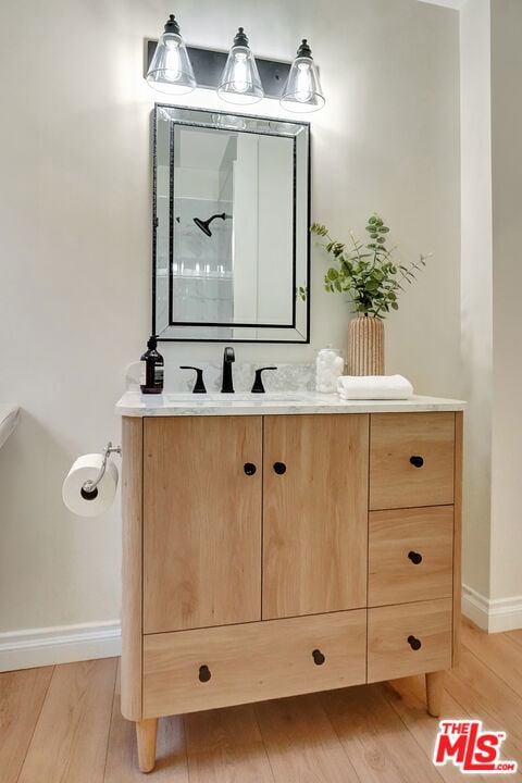 bathroom with vanity, hardwood / wood-style floors, and walk in shower