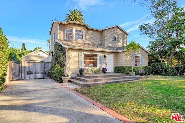 view of front of home with an outbuilding, a garage, and a front yard