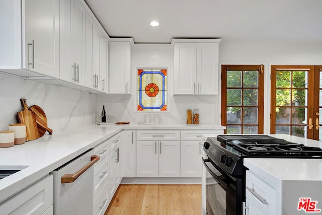 kitchen with black range with gas cooktop, white cabinetry, light hardwood / wood-style floors, decorative backsplash, and stainless steel dishwasher