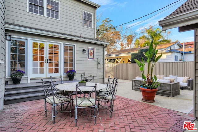 view of patio featuring an outdoor living space and french doors