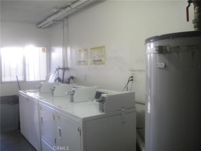 shared laundry area with water heater and washer and clothes dryer