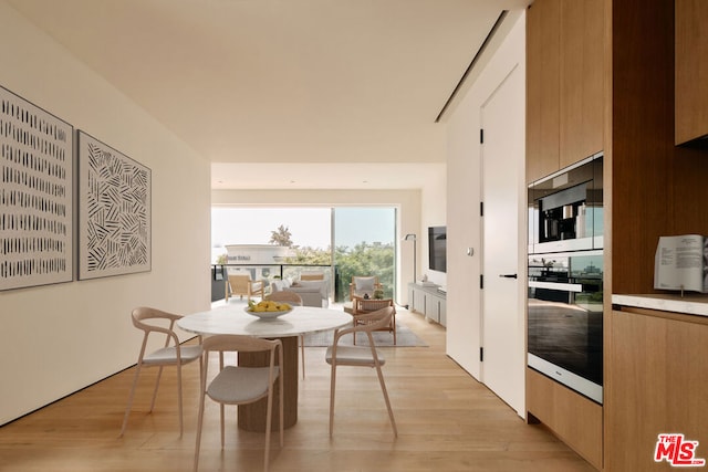 dining space with light hardwood / wood-style floors