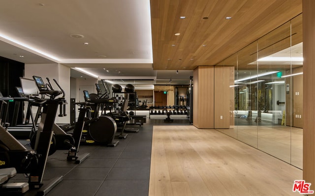 gym with hardwood / wood-style flooring and wood ceiling