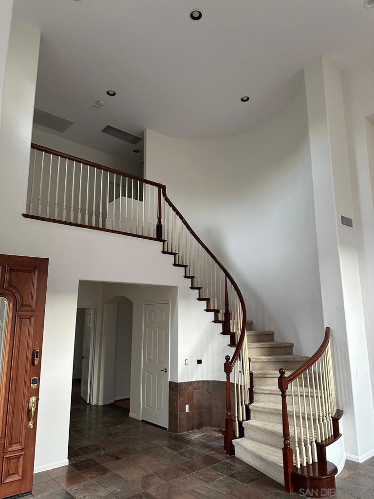 staircase with a towering ceiling