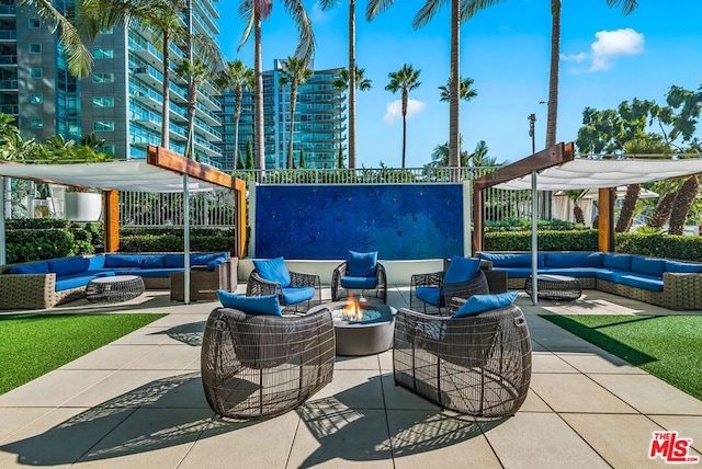 view of patio / terrace with a pergola and an outdoor living space with a fire pit