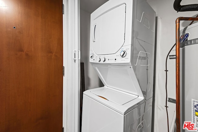 laundry room featuring stacked washer and clothes dryer