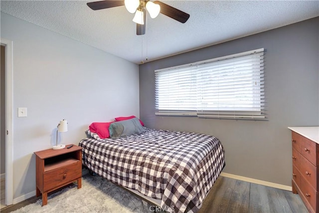 bedroom with ceiling fan, a textured ceiling, and light hardwood / wood-style flooring