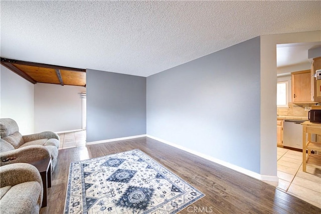 living room featuring a textured ceiling and light wood-type flooring