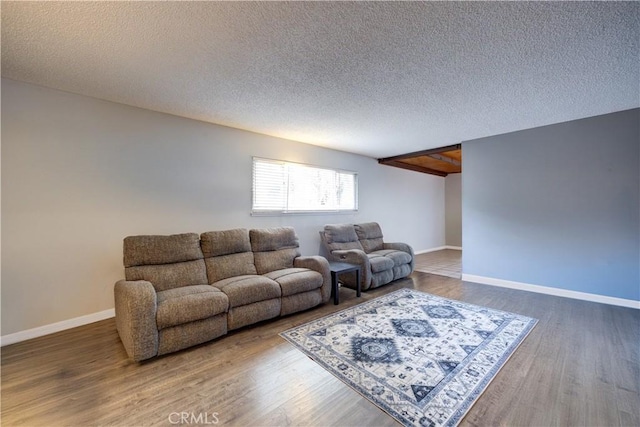 living room with wood-type flooring and a textured ceiling