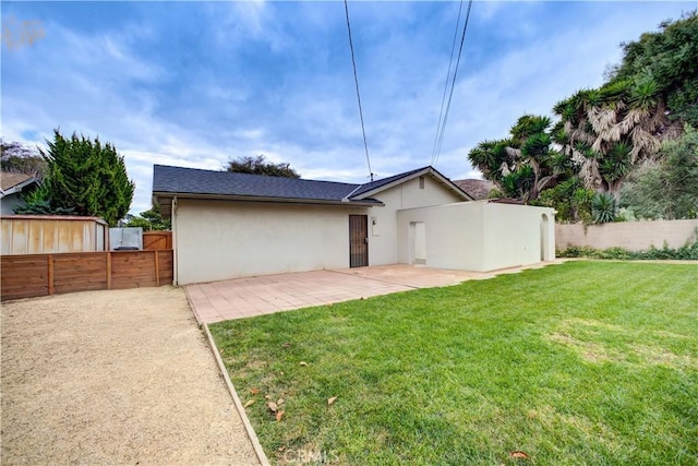 exterior space with a front yard and a patio area