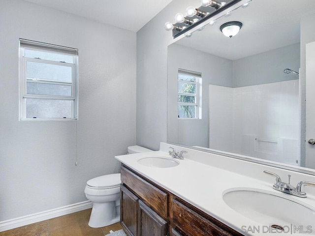 bathroom with a shower, tile patterned floors, toilet, and vanity