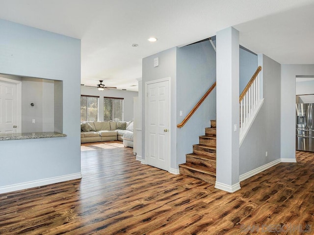 unfurnished living room with ceiling fan and dark hardwood / wood-style floors