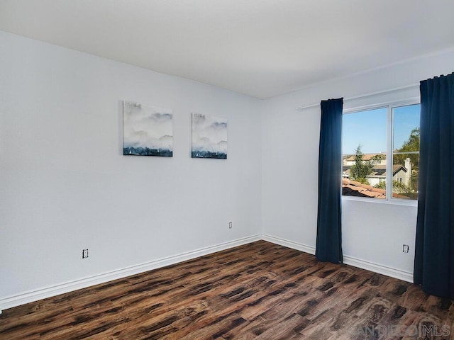 empty room with dark wood-type flooring