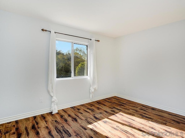 spare room with hardwood / wood-style floors