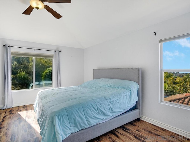 bedroom featuring ceiling fan, dark hardwood / wood-style floors, and vaulted ceiling