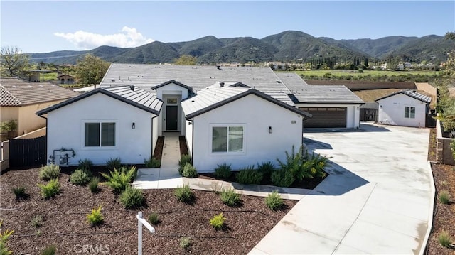 view of front of property with a mountain view and a garage