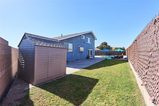 view of yard featuring a patio and a shed