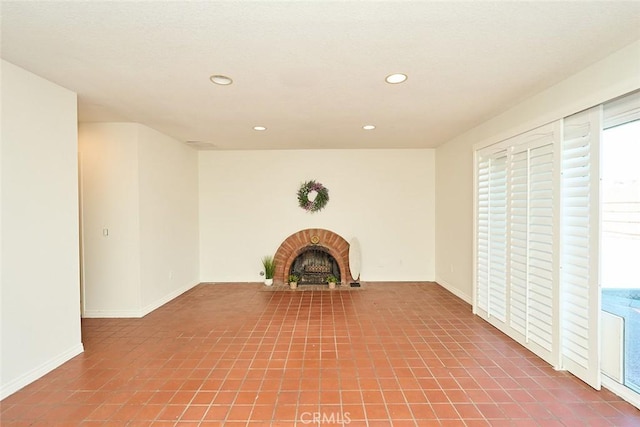 unfurnished living room with a brick fireplace