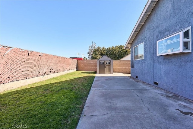 view of yard with a patio and a shed