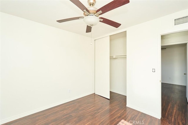 unfurnished bedroom with ceiling fan and dark hardwood / wood-style floors