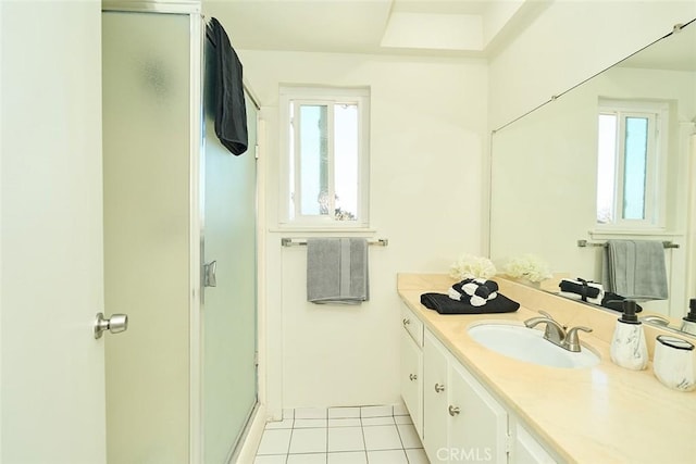 bathroom with vanity, a wealth of natural light, tile patterned floors, and a shower with door