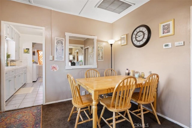 dining room with washer / clothes dryer and light tile patterned floors