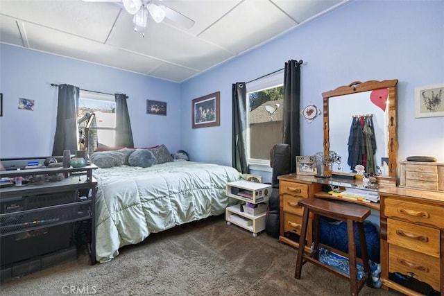 bedroom featuring ceiling fan and dark carpet