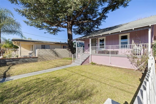 view of front of home with a front yard and covered porch