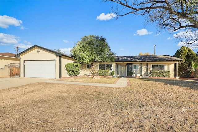 single story home featuring a garage and a front yard