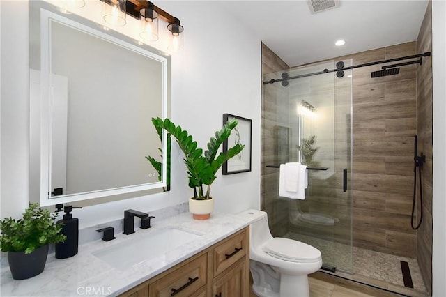 bathroom with vanity, toilet, and an enclosed shower