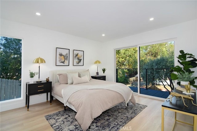 bedroom with light hardwood / wood-style flooring and access to outside