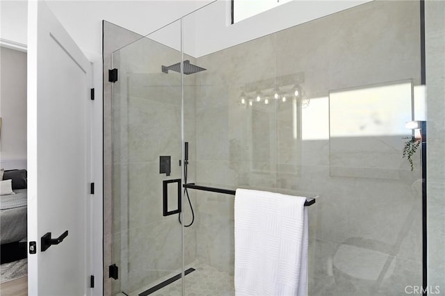 bathroom with a shower with door