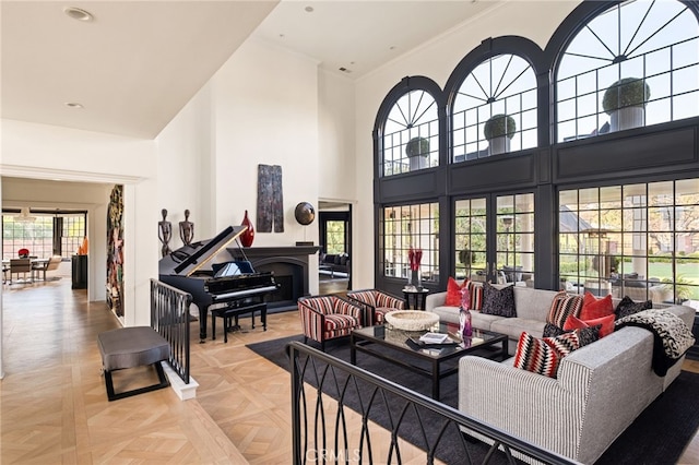 living room featuring a towering ceiling and light parquet flooring