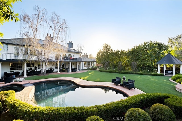 view of pool featuring a yard, a gazebo, and a patio area