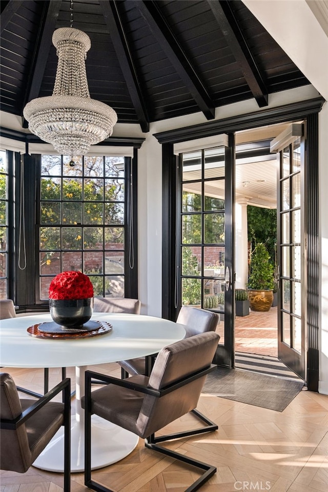 sunroom featuring wooden ceiling, vaulted ceiling with beams, a notable chandelier, and french doors